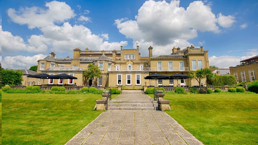 Exterior of Chilworth Manor with landscaped gardens