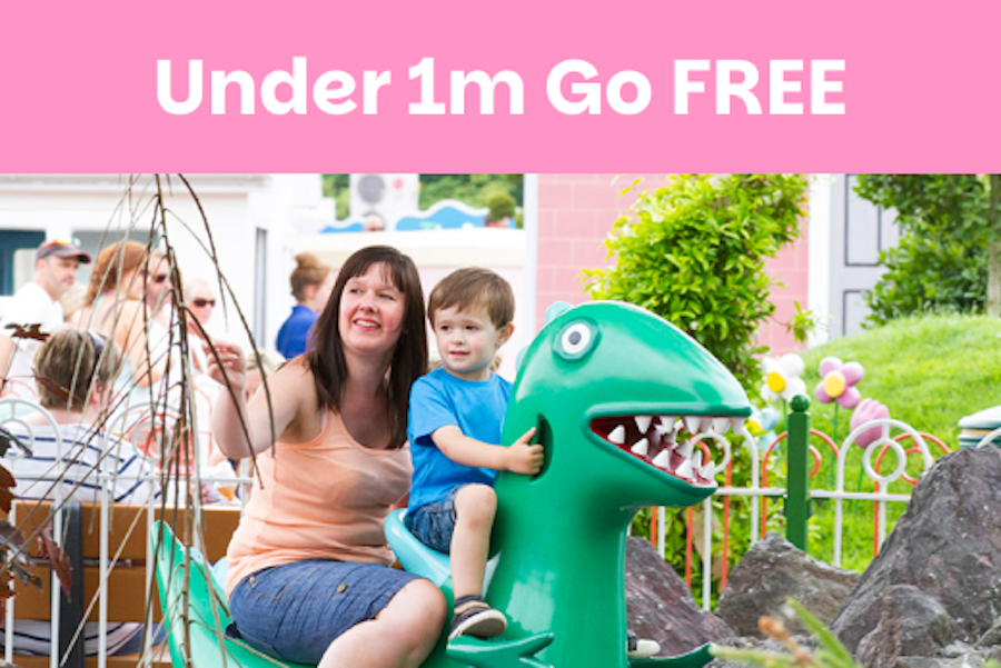 Photo of two animated pig characters interacting with a family outside a building. A badge in the corner reads 'Under 1m Play FREE'.