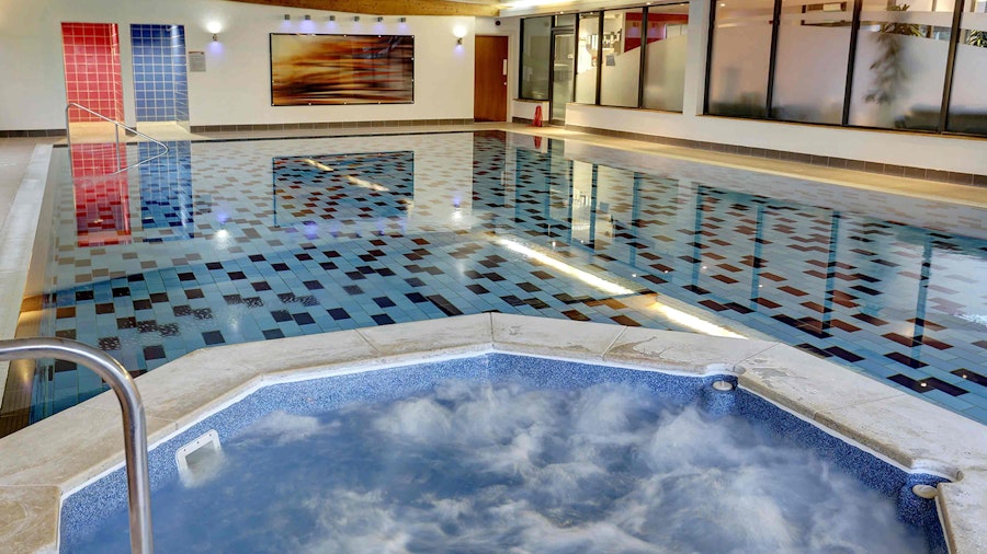 Modern looking swimming pool with hot tub