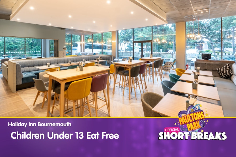 Hotel restaurant dining area with offer text: Children under 13 eat free.