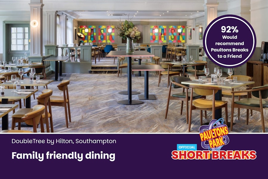 Hotel restaurant with tables set up for dinner