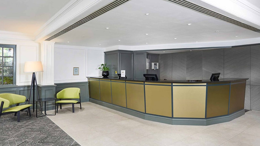 Hotel reception desk with grey and green colour palette