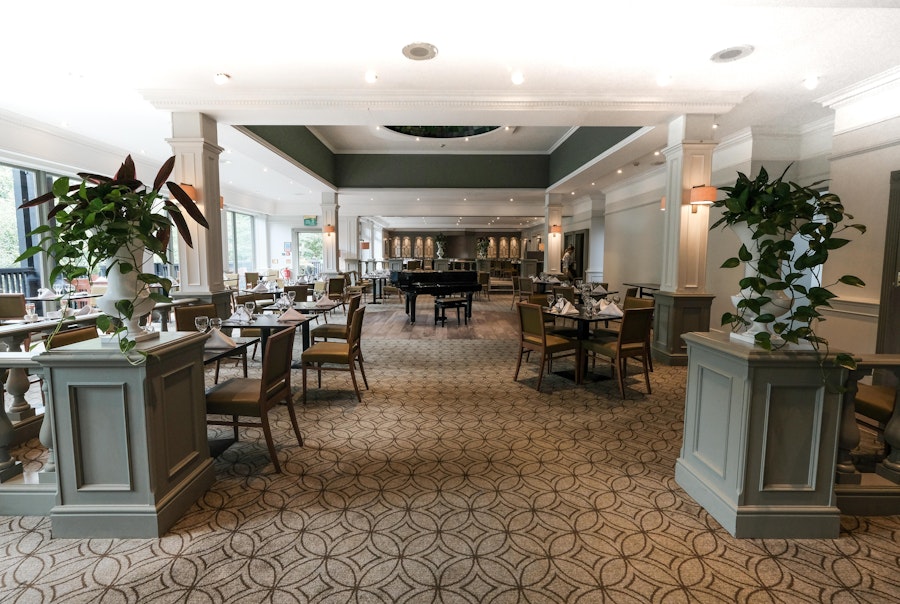 Hotel restaurant with tables set up for dinner