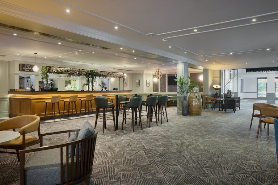 Hotel restaurant with tables set up for dinner