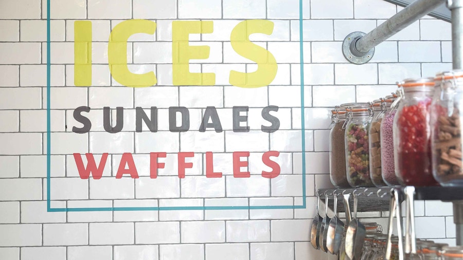 Food station with sign saying Ices, sundaes, waffles